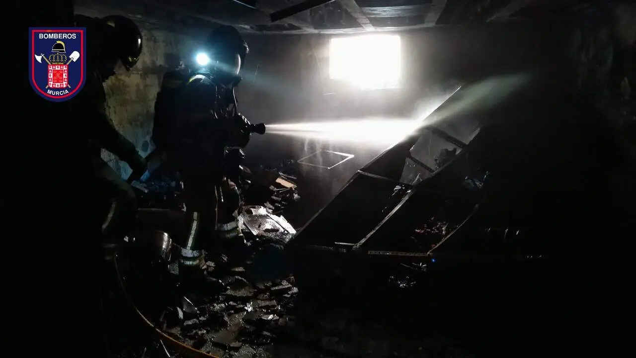 Bomberos trabajando en el interior del garaje incendiado este viernes en el barrio murciano de Santiago el Mayor (foto: Bomberos de Murcia)