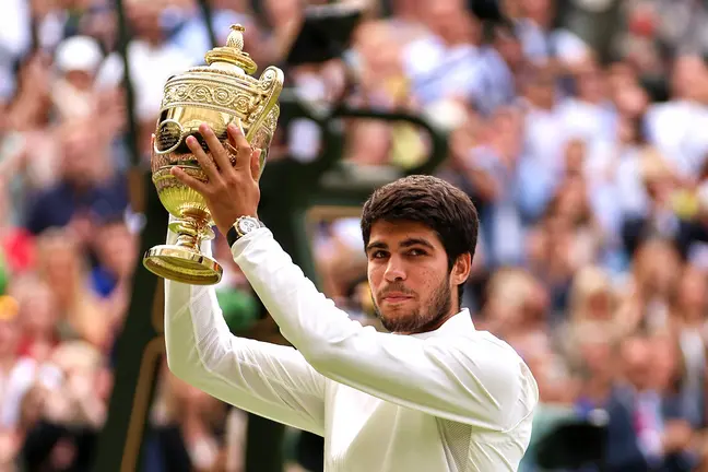 LONDON, ENGLAND - JULY 16: Carlos Alcaraz of Spain lifts the Men's Singles Trophy following his victory in the Men's Singles Final against Novak Djokovic of Serbia on day fourteen of The Championships Wimbledon 2023 at All England Lawn Tennis and Croquet Club on July 16, 2023 in London, England. (Photo by Clive Brunskill/Getty Images)