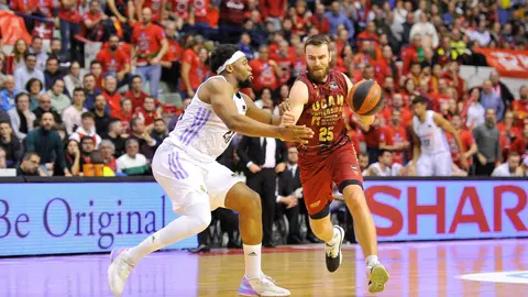 El jugador del UCAM Radovic avanza con el bal&oacute;n ante un jugador del Real Madrid