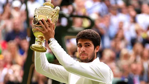 LONDON, ENGLAND - JULY 16: Carlos Alcaraz of Spain lifts the Men's Singles Trophy following his victory in the Men's Singles Final against Novak Djokovic of Serbia on day fourteen of The Championships Wimbledon 2023 at All England Lawn Tennis and Croquet Club on July 16, 2023 in London, England. (Photo by Clive Brunskill/Getty Images)