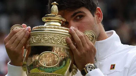 El murciano Carlos Alcaraz besa el trofeo tras vencer a Novak Djokovic en la final del torneo de Wimbledon (foto: EFE)