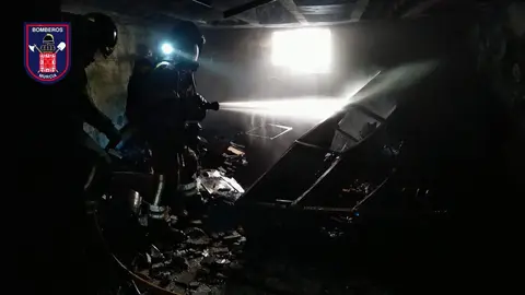 Bomberos trabajando en el interior del garaje incendiado este viernes en el barrio murciano de Santiago el Mayor (foto: Bomberos de Murcia)